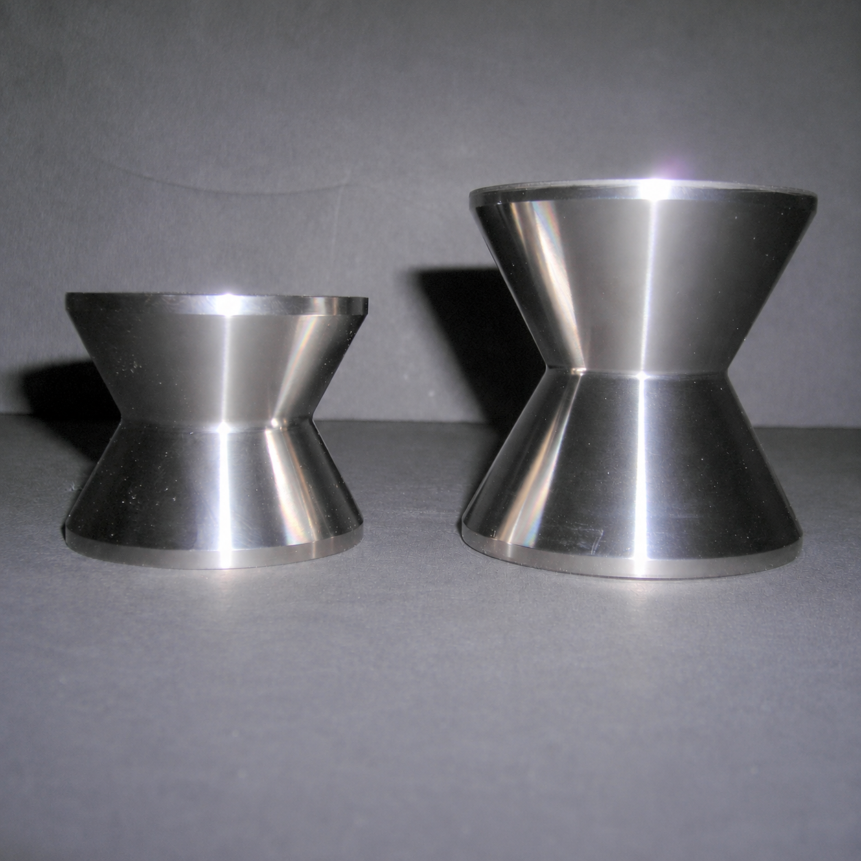 Two machined ballerina rollers with concave wire grooves, in two sizes