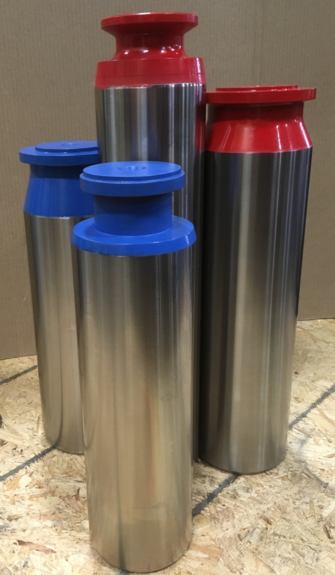 Manufactured fracking plungers with mirror-polished coated barrels, grouped by size