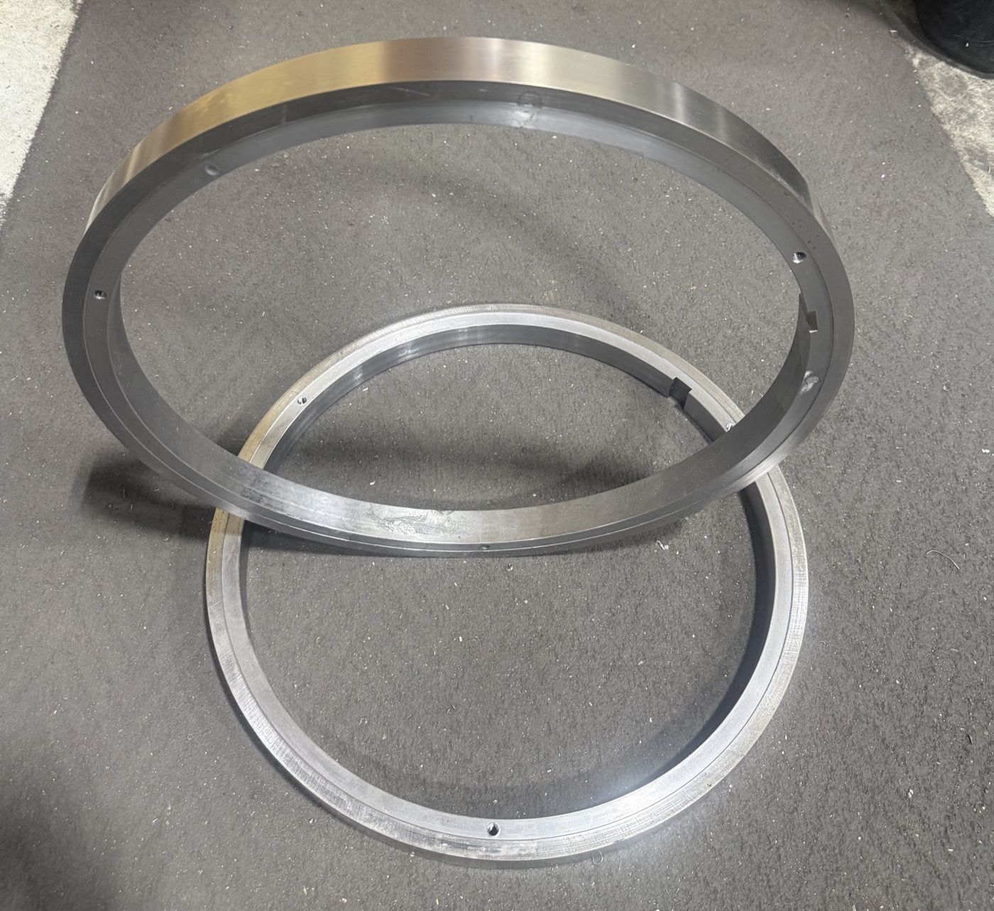 Two large fuse-welded rings, machined and finished, on the shop floor