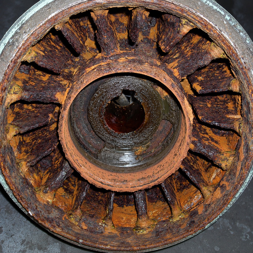 Interior of a water-cooled wire drawing block before treatment, the cooling passages heavily rusted and scaled